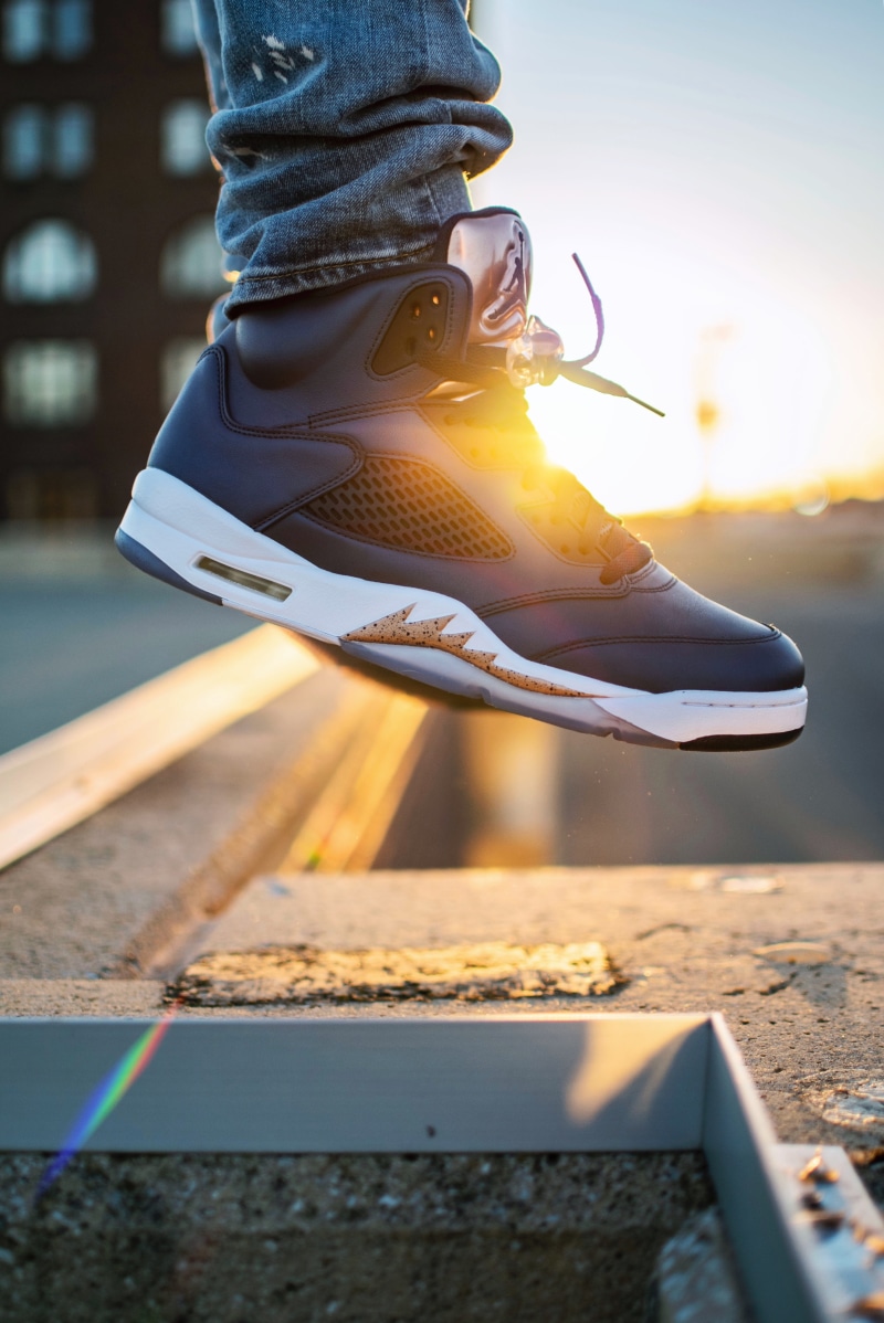person, one person, sport, body part, human leg, shoe, jumping, boot, city, sunlight, day, 5K, levitation, nature, hi-top, denim, black, outdoors, leisure activity