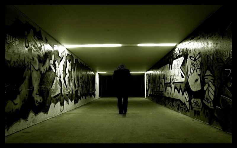 real people, frame, one person, bed, wooden, walking, public transportation, rear view, illuminated, the way forward, graffiti, direction, wall - building feature