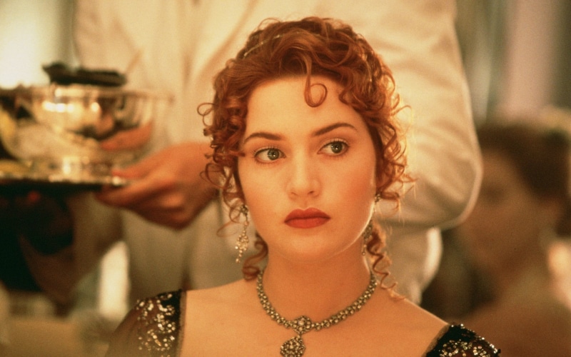 looking at camera, Titanic, jewelry, necklace, focus on foreground, real people, hairstyle, Kate Winslet, beautiful woman, curly hair, headshot, one person