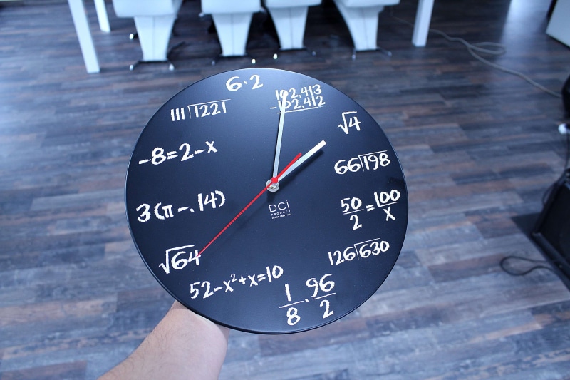human body part, wood, floor, travel, indoors, transportation, mathematics, wristwatch, number, minute hand, hand, time, clock, agency, math, accuracy