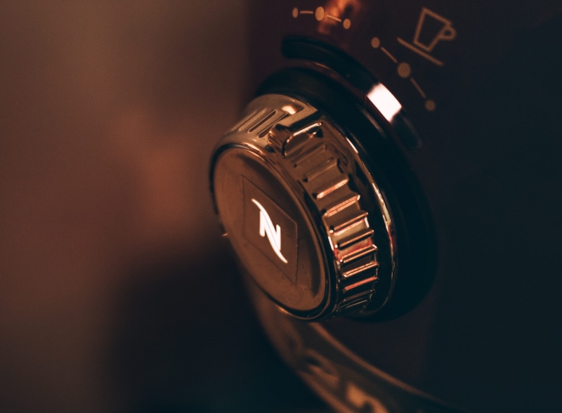 photo, single object, retro styled, studio shot, copy space, illuminated, coffee machine, headphones, lens - optical instrument, technology, indoors, black color