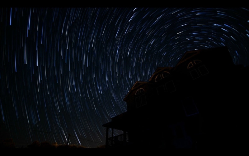 low angle view, black, galaxy, sky, stars, nature, star trail, astronomy, architecture, building exterior, space, gray, blurred motion, star trails, motion