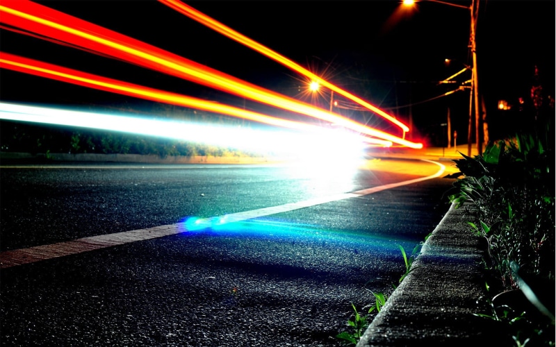 outdoors, glowing, lighting equipment, street, motion, light trails, architecture, multi colored, road, light beam, long exposure, speed, street light