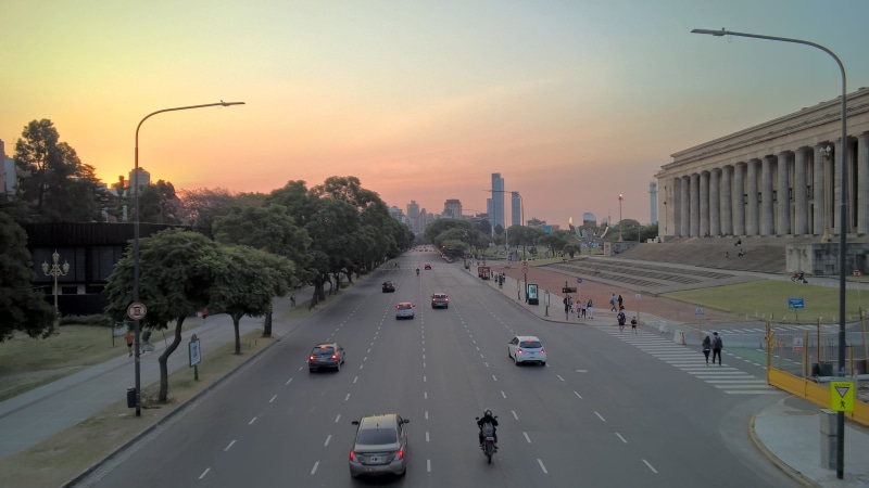 avenue, city, architecture, skyline, transportation, facultad de derecho, building exterior, mode of transportation, car, sign, nature, sunset, diminishing perspective