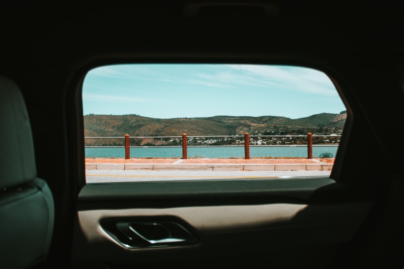focus on background, water, transparent, mountain, vehicle, body, nautical vessel, distant, transportation, house, backseat, building, villa, housing, car