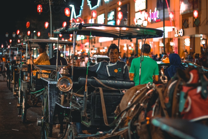 amusement park ride, building exterior, workers, old man, malioboro street, old, outdoors, travel, places, real people, street, night, yogyakarta, people