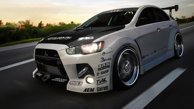transportation, sky, Mitsubishi Lancer Evo X, close-up, stationary, 1080P, wheel, text, motor vehicle, mitsubishi, silver colored, no people, black color