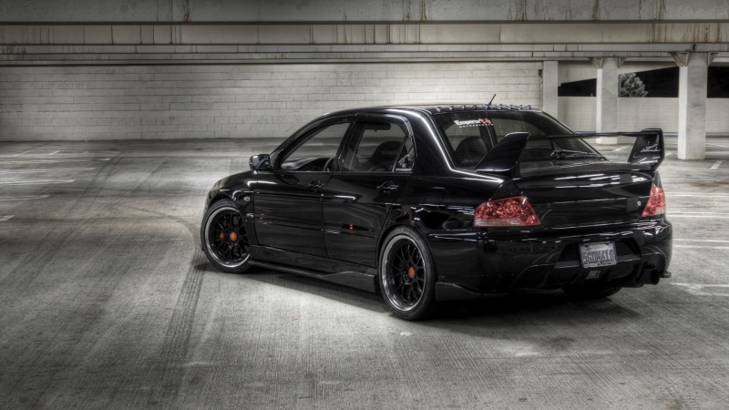 building exterior, garage, street, parking, weapon, mode of transportation, Mitsubishi Lancer, no people, day, outdoors, travel, architecture, Mitsubishi