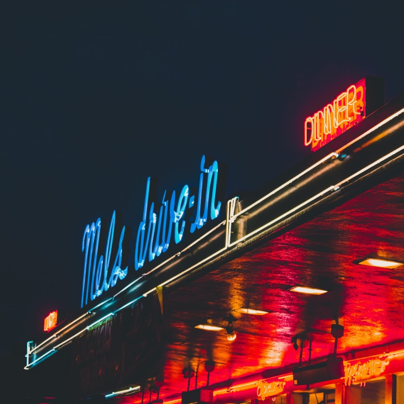 lighting equipment, building exterior, red, city, western script, low angle view, sign, blurred motion, no people, neon, san francisco, motion, text, sky