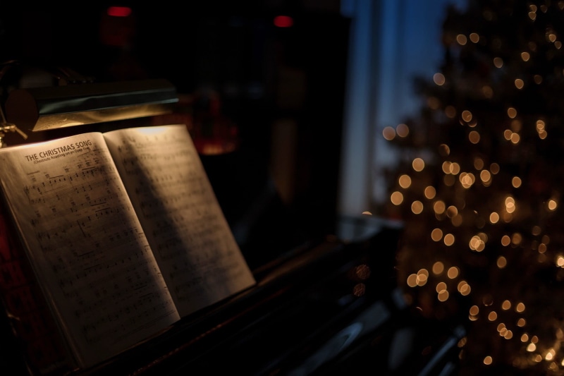 publication, belief, text, holiday, decoration, cabinet, night, book, illuminated, focus on foreground, no people, celebration, paper, piano, arts culture and entertainment