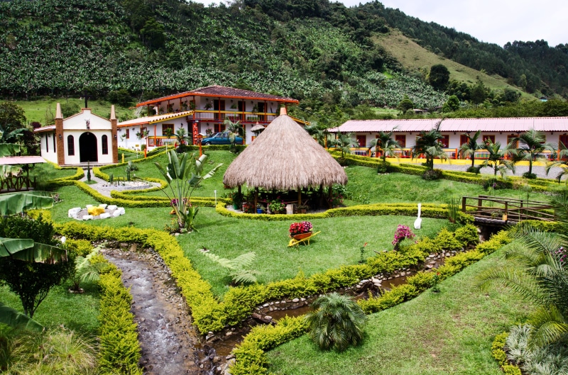 coffee-growing area, banana tree, Coffee, lawn, architecture, building exterior, tree, hut, outdoors, day, green color, hedge, hotel, rural scene, building