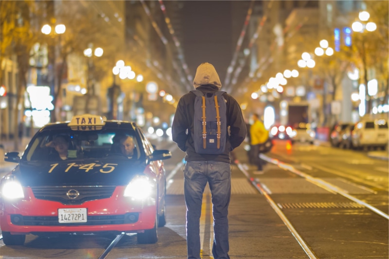 road, motor vehicle, city, government, transportation, middle, mode of transportation, wearing, man, cars, evening, urban, street, uniform, pants, headlight