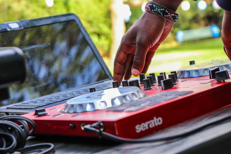 travel, person, hand, human body part, outdoors, laptop, dj, transportation, car, musician, men, blurred background, focus on foreground, instrument, land vehicle