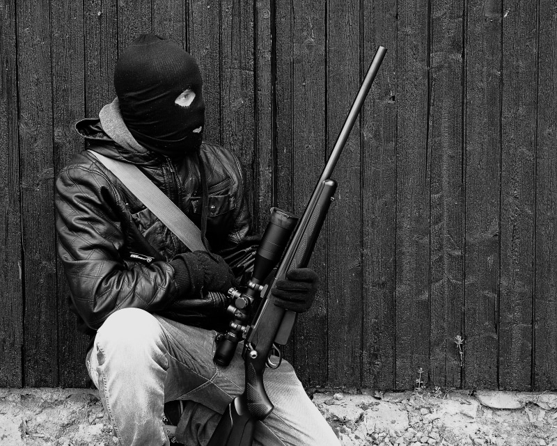 rifle, balaclava, protection, lifestyles, real people, clothing, weapons, masquerade, young men, men, jacket, sitting, three quarter length, military, telescopic sight
