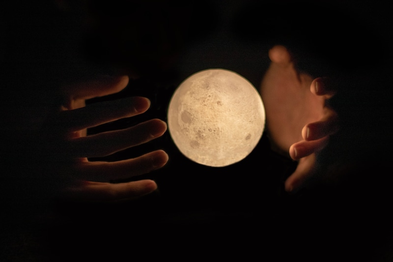 one person, headshot, food and drink, astronomy, indoors, hand, moon, human body part, men, hands, holding, fantasy, adult, real people, dark, side view