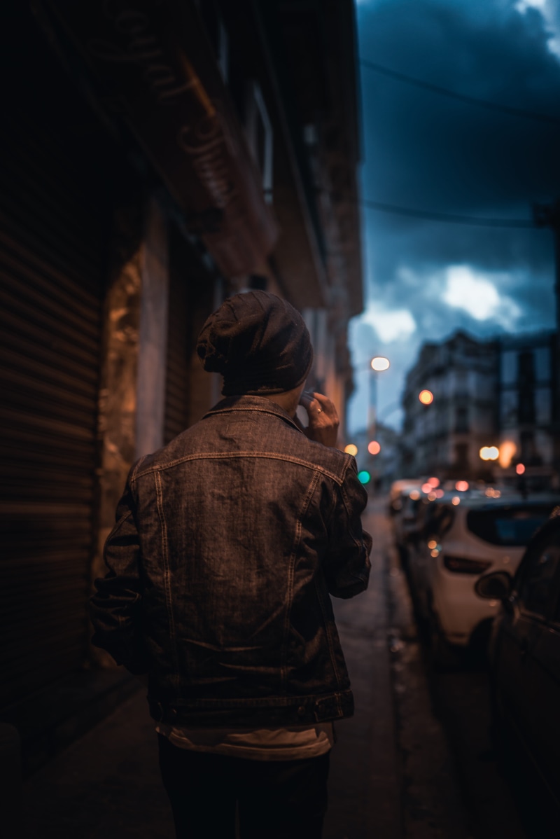 city, rear view, building exterior, street, standing, ring, leisure activity, jacket, urban, building, denim, focus on foreground, illuminated, real people