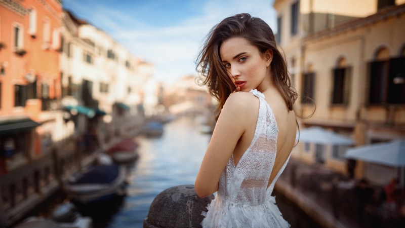 standing, looking at viewer, dress, brown hair, architecture, young adult, adult, one person, Georgy Chernyadyev, focus on foreground, hairstyle, 1080P
