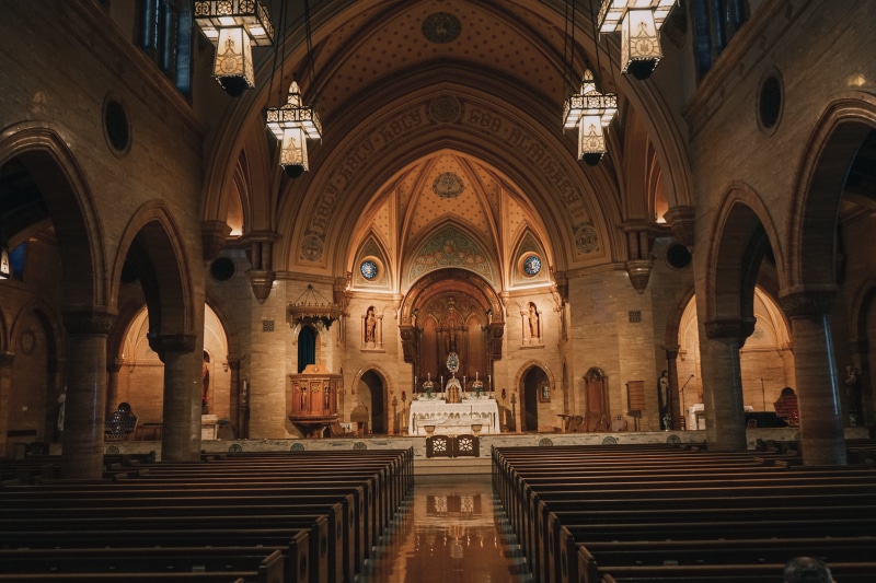 housing, church, arched, inside, lighting, place of worship, tourism, building, spirituality, incidental people, altar, belief, chairs, brown, crypt, architecture and art
