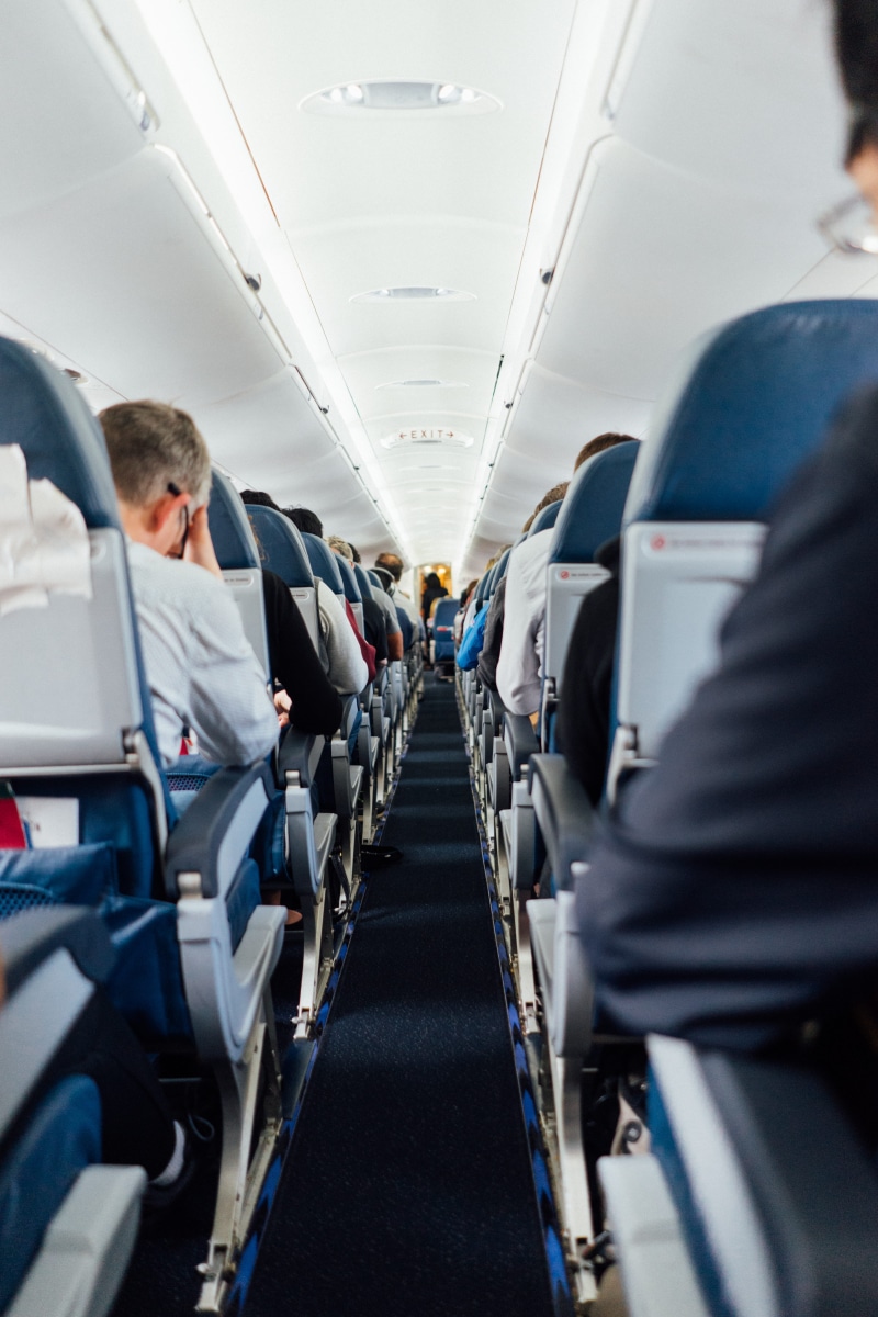 seating, vehicle interior, uniform, travel, inside, ceiling, aisle, mode of transportation, journey, seats, plane, in a row, seat, airplane, airplane aisle