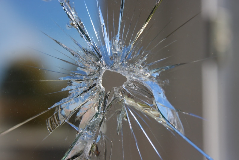bad condition, glass - material, disc, focus on foreground, fragility, destruction, fragile, school, clear, bullet hole, day, outdoors, slingshot, aggression