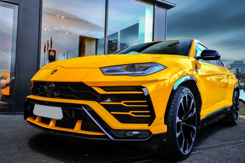 yellow, transportation, built structure, car, parking garage, stationary, poster, sports utility vehicle, mode of transportation, landscape, street, city