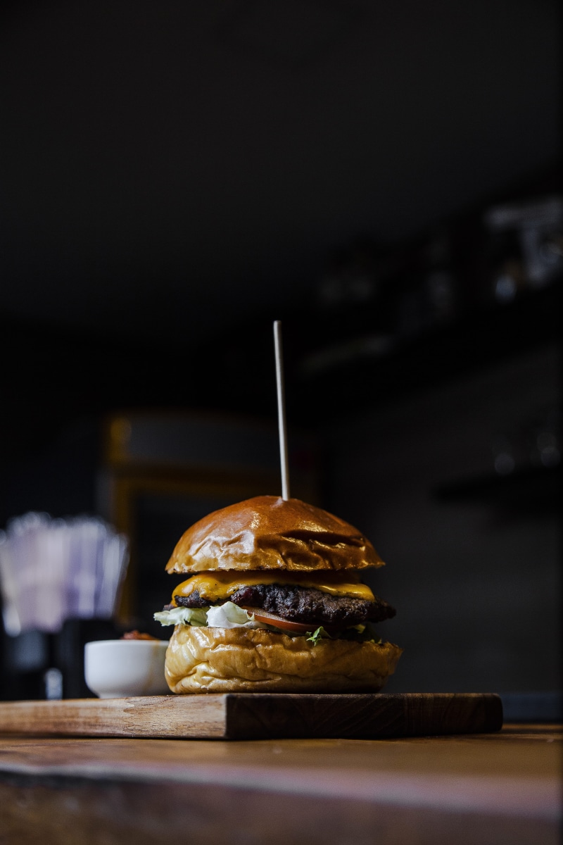 food styling, studio shot, snack, sandwich, food presentation, selective focus, unhealthy eating, indoors, business, bun, 5K, no people, food, burger