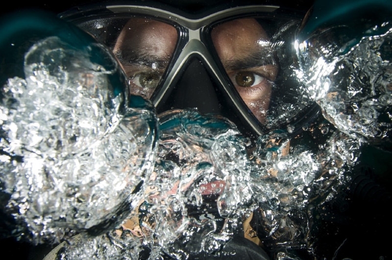 swimming, underwater, snorkeling, real people, goggles, adventure, sport, portrait, lifestyles, wearing, water, close-up, looking at camera, headshot, ocean