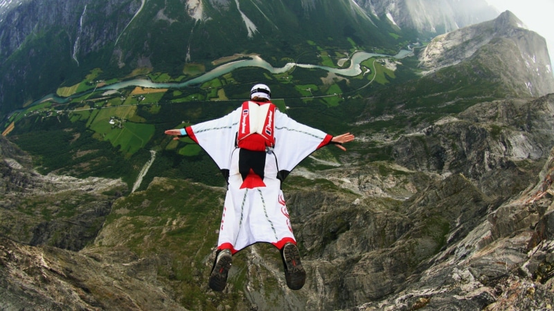 beauty in nature, non-urban scene, person, men, river, red, sport , mountains, white, nature, jumping, flying, trees, day, parachutes, basejumping, real people