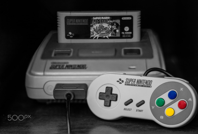 communication, selective focus, remote control, retro games, 1080P, toy, table, no people, retro styled, indoors, control, Super Nintendo, close-up, western script