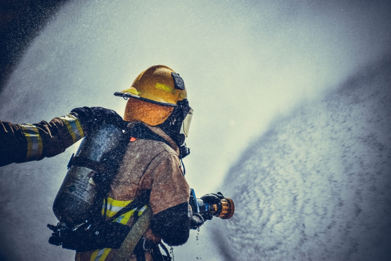 warm clothing, sea, adventure, fire fighters, people, aquatic sport, safety, men, helmet, hose, water, real people, outdoors, fireman, person, equipment