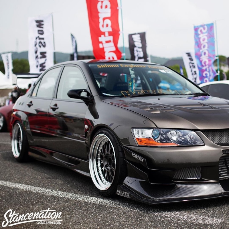 built structure, text, brown, building exterior, street, lowered, sign, parking, JDM, western script, focus on foreground, Stance, city, control, mode of transportation