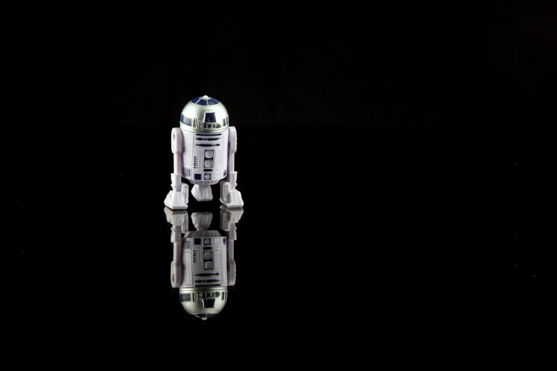 rd2d, indoors, single object, d, night, starwars, black background, studio shot, copy space, r, war of the galaxies, arturito, illuminated, surface, robot