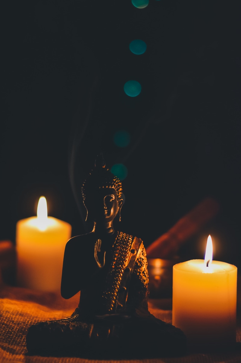 nature, fire, belief, male likeness, close-up, spirituality, sculpture, sitting, illuminated, flame, art and craft, heat - temperature, indoors, fire - natural phenomenon