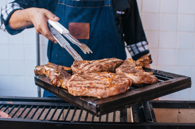 tray, holding, human body part, meat, human hand, dinner, meal, apron, delicious, steak, men, lunch, food and drink, hand, midsection, metal, person, one person