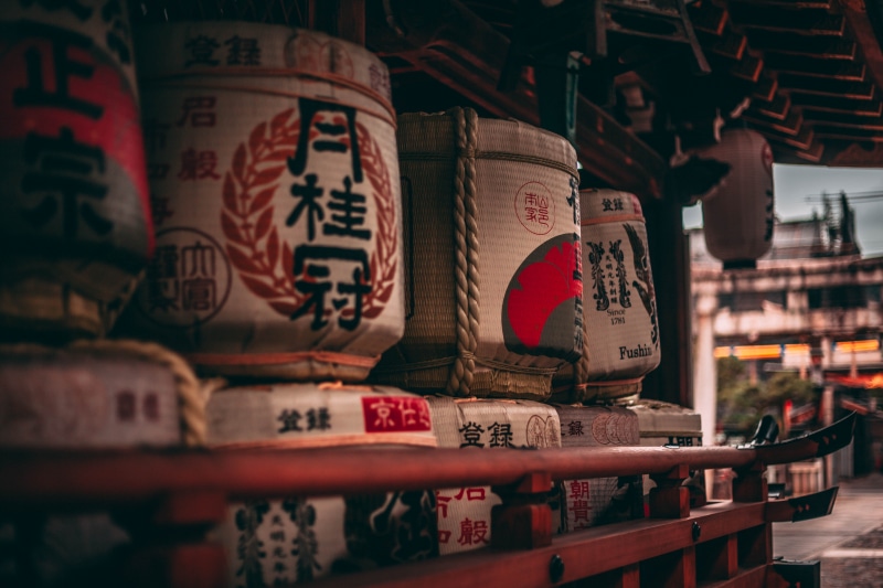 selective focus, no people, liquor, place of worship, kyoto, alcohol, white, religion, communication, basket, close-up, sake, belief, art and craft, japanese temple