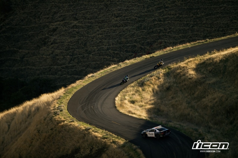 transportation, outdoors, motor vehicle, curve, landscape, high angle view, environment, police, winding road, plant, motorcycle, mode of transportation