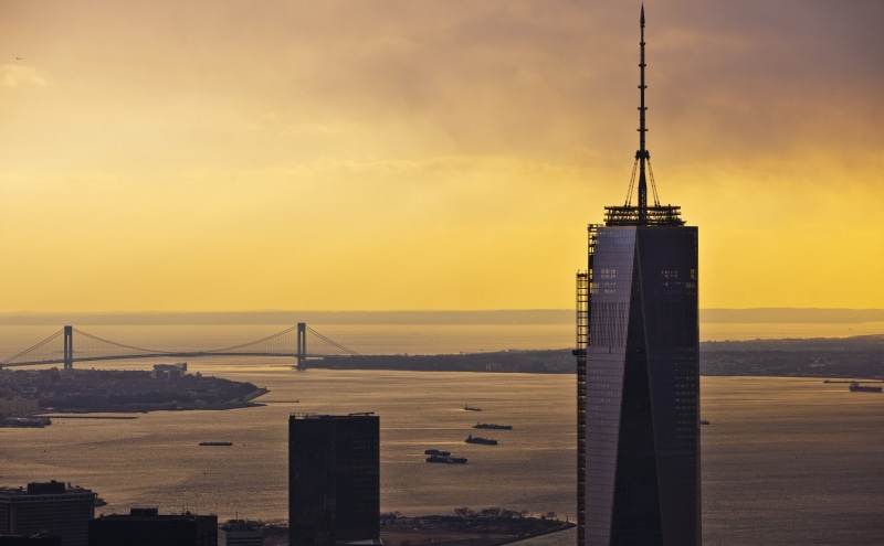 center, outdoors, verrazanobridge, bay, New York, cloud - sky, yellowsky, city, building exterior, york, United States, water, building, orange color, world