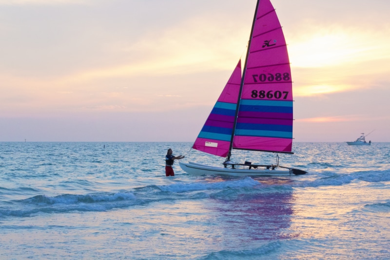 shore, paradise, surfing, sunset, horizon over water, sunshine, seashore, yachting, vessel, beach, nature, sun, resort, aquatic sport, wave, sunlight, pink sunset