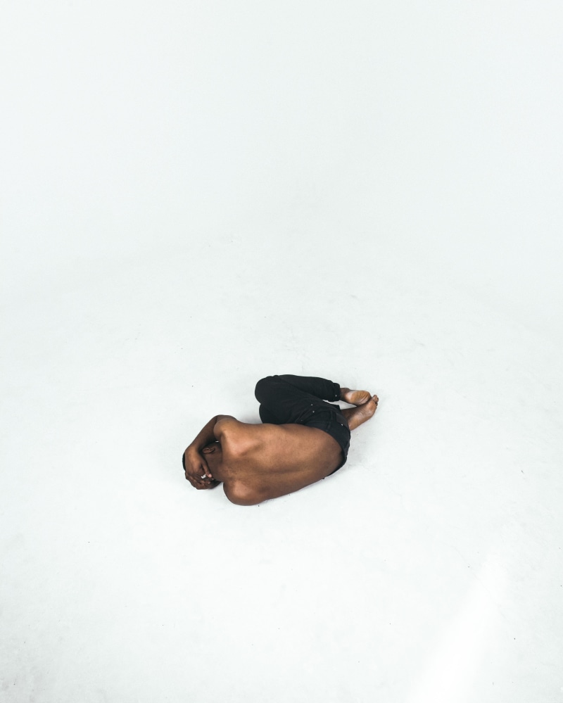 white background, pain, leisure activity, fear, white color, men, black lives matter, studio shot, lying, person, lying down, fetal position, blm, surface