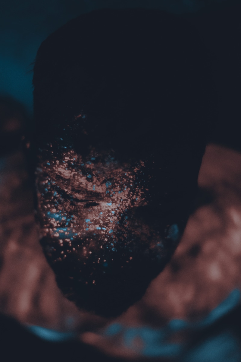 studio shot, emotion, man, one person, men, adult, dark, light, body part, lifestyles, blacklight, snow, darkness, indoors, midsection, drink, hope, dirt