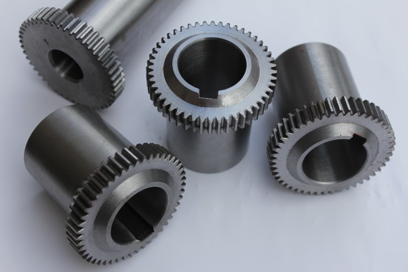 gray, group of objects, still life, white background, no people, machine Part, studio shot, gear, machinery, gears, teamwork, 5K, technology, turning