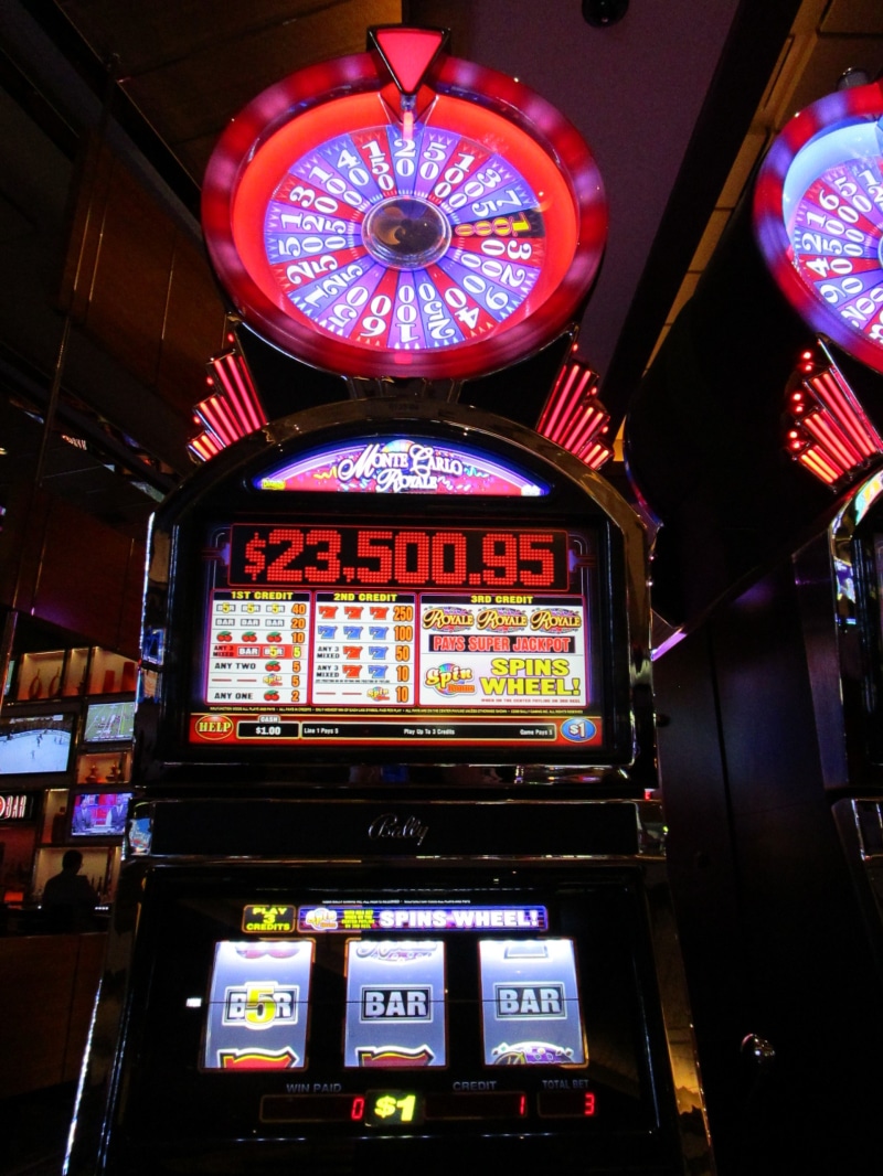 arts culture and entertainment, ceiling, text, built structure, luck, arcade, indoors, casino, architecture, advertisement, addiction, night, machine, chance