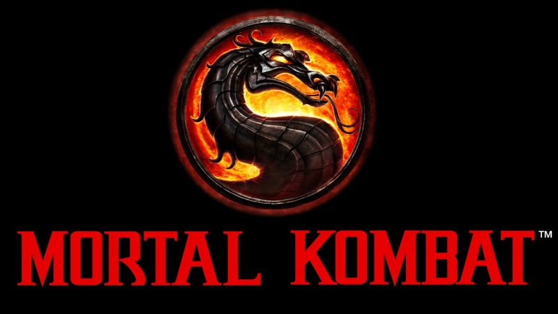 no people, neon colored, mortal, glowing, text, kombat, low angle view, communication, logo, night, representation, close-up, red, architecture, outdoors