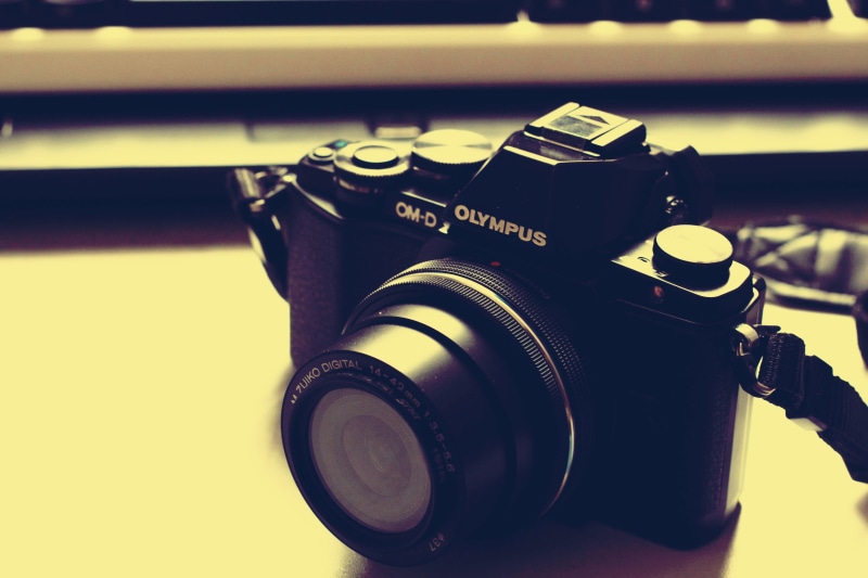 table, photographing, photographic equipment, camera - photographic equipment, indoors, technology, western script, lens, text, lens - optical instrument