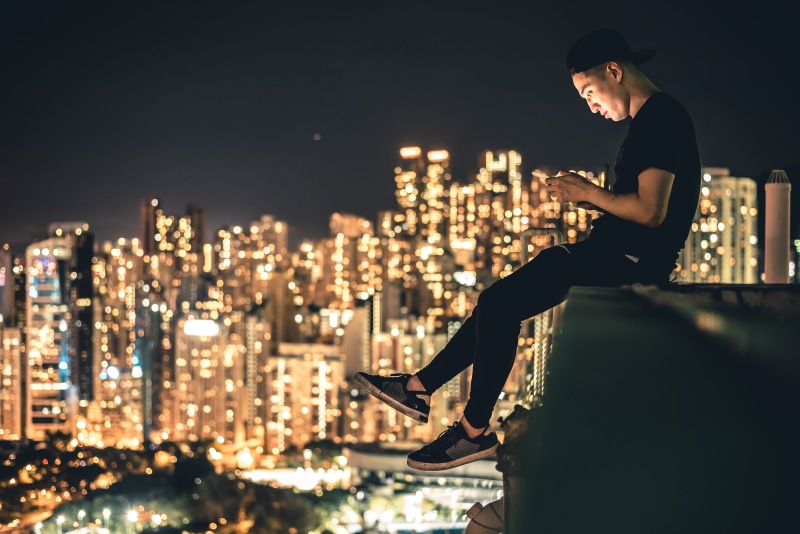 rise, wireless technology, buildings, cityscape, t, adult, city, sneakers, black, sky, urban Skyline, shirt, black cap, residential district, night, young adult