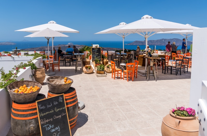 day, land, brown, group of people, sunshade, landscape, restaurant, person, table, roof, seat, nature, travel, meal, patio, island, travel destinations