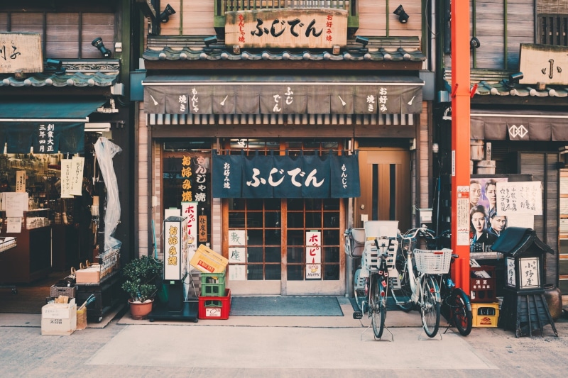 outdoors, sign, entrance, mode of transportation, no people, non-western script, step, white, facade, communication, front, black, architecture, street