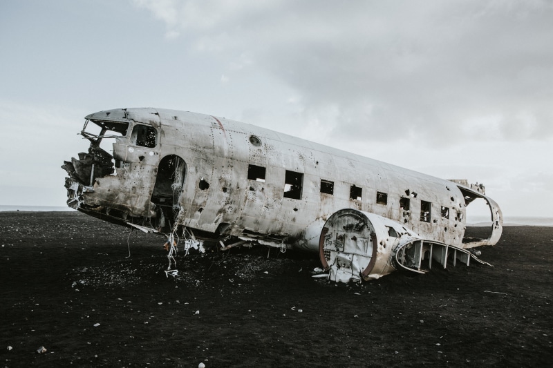 parts. clouds, military airplane, white, obsolete, overcast, ruined, window, outdoors, navy, wrecked, wreck, demolished, travel, items, damage, airline