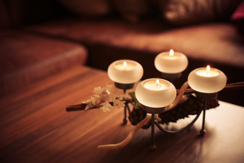 heat - temperature, table, sitting, fire, indoors, christmas decoration, spirituality, holidays, lighting equipment, selective focus, candlelight, tea light