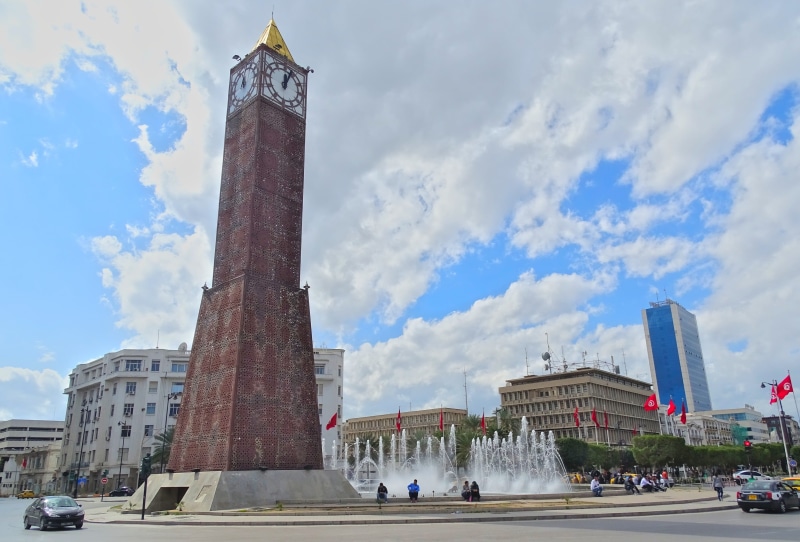 building, incidental people, Tower, city, tunisia, built structure, office building exterior, travel, architecture, low angle view, transportation, outdoors
